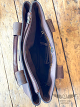 Picture of one of the 3 fabric lined compartments of the westward tote.  Image shows inside zipper pocket, conceal carry holster, and magnetic closure